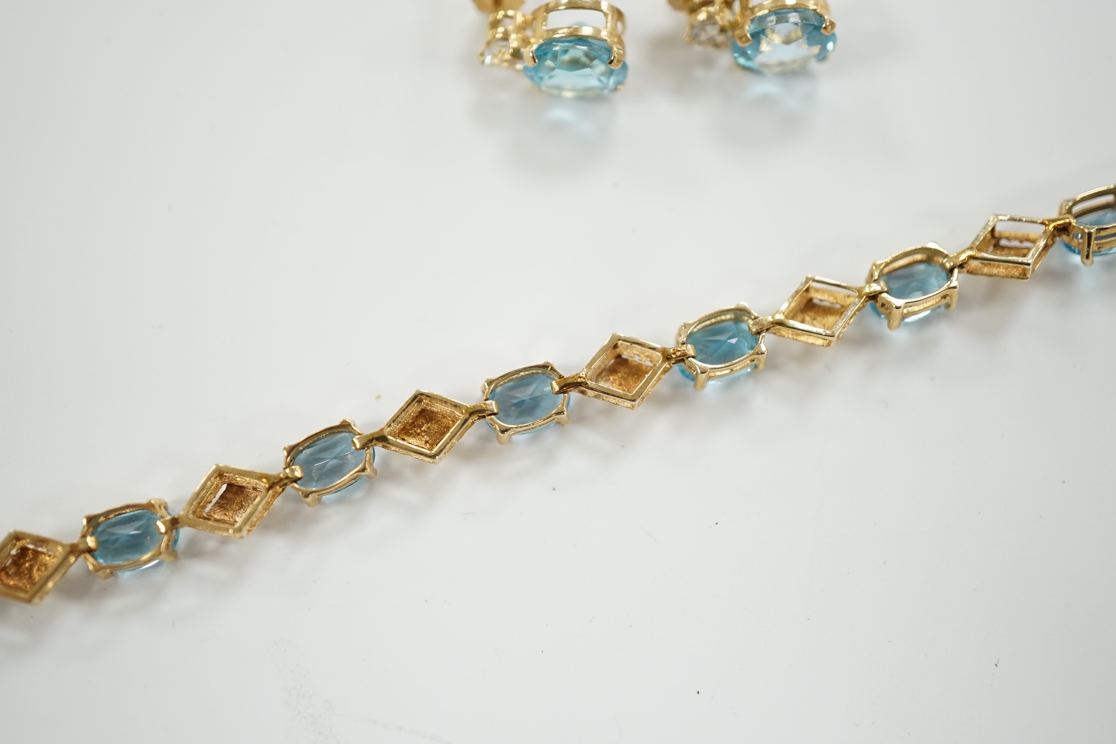 A modern 9ct gold and blue topaz? cluster set bracelet, 18.5cm, together with a pair of 9ct, blue topaz? and simulated diamond set ear studs, gross weight 6.6 grams.